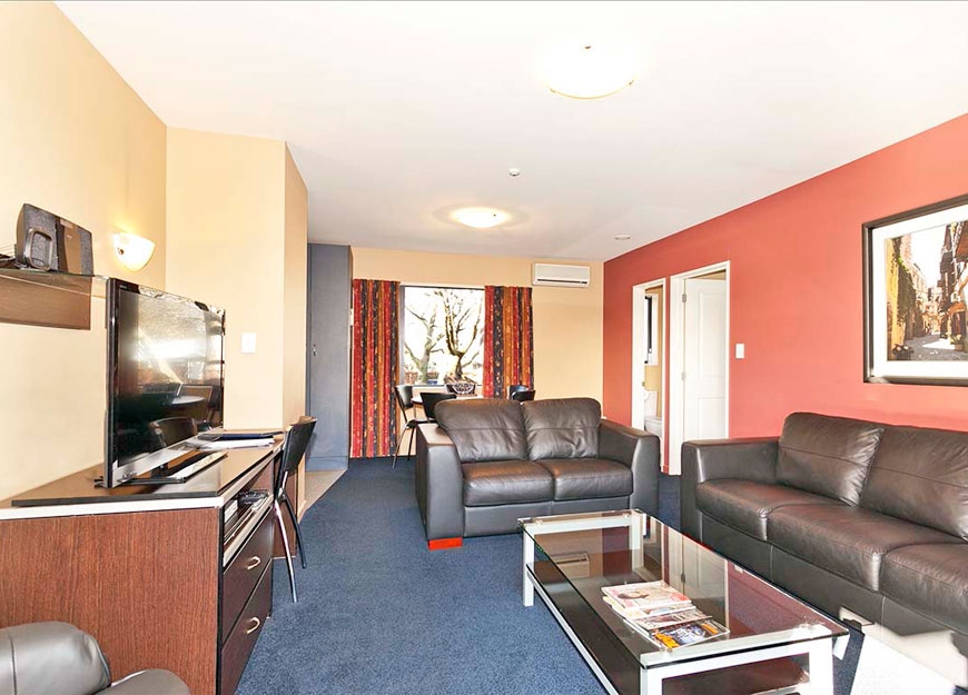 spacious lounge with comfortable sofas and 40-inch LED TV