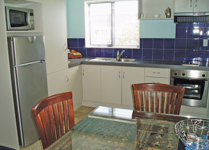 fully-equipped kitchen with dining table